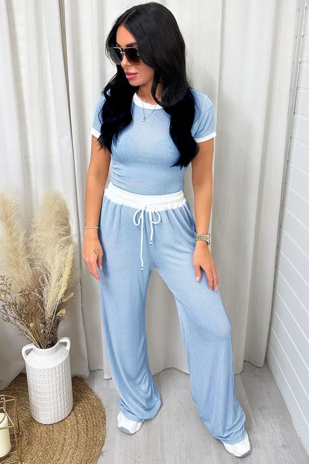 Blue ribbed lounge set with contrast trim t-shirt and wide-leg pants.