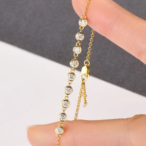 Gold bezel-set moissanite tennis bracelet with adjustable clasp