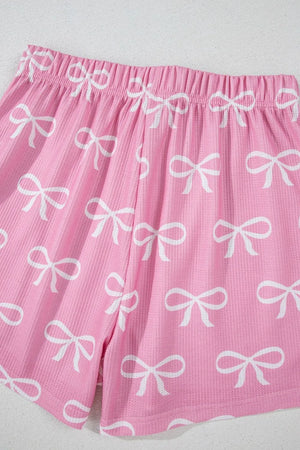 Pink ribbed lounge shorts with allover white bow print and elastic waistband.