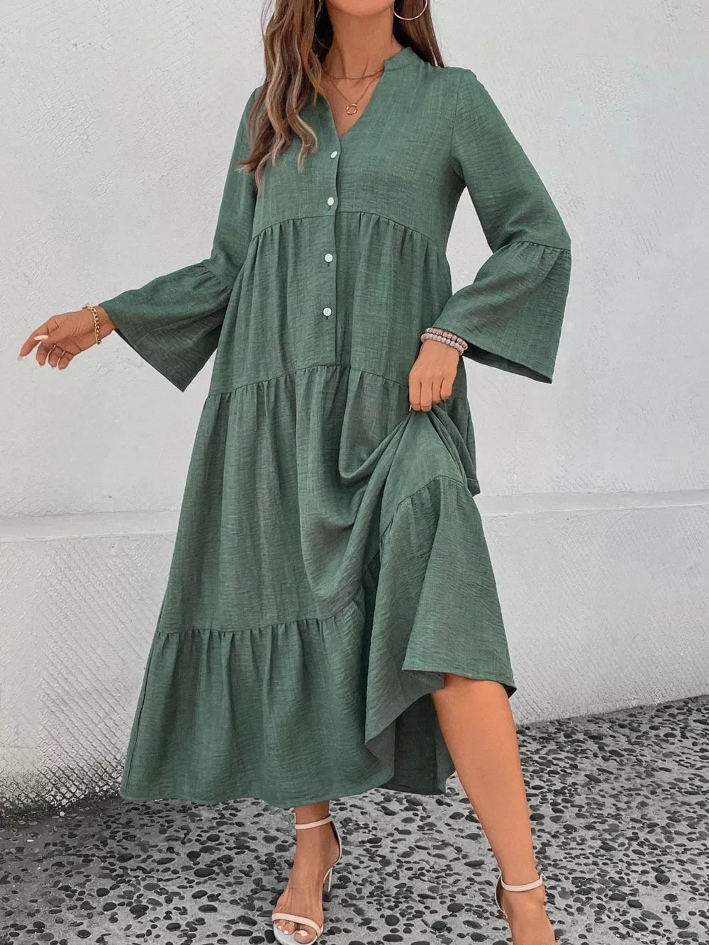 Green tiered ruffle hem v-neck dress with button front and bell sleeves.
