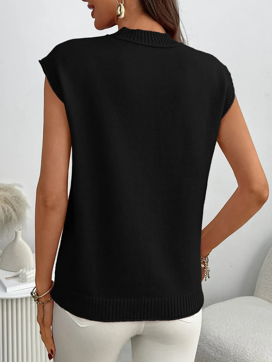 Black ribbed knit sleeveless mock neck top with a relaxed fit.