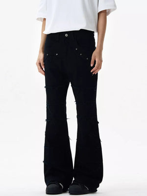 Black stretch flare jeans with frayed hem details and distressed accents.