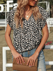 Leopard print V-neck blouse with short sleeves and tie detail.