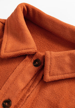 Colorblock plaid shacket in terracotta with button front and contrast cuffs.