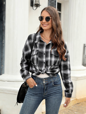 Plaid button-up shirt in black and white with two chest pockets, tied at the waist.
