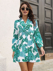 Teal paisley print shirred waist mini dress with long sleeves and a collared neckline.
