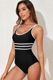 Black one-piece swimsuit with white stripe trim and scoop neckline.