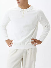 White cotton knit polo shirt with ribbed sleeves and a button placket.