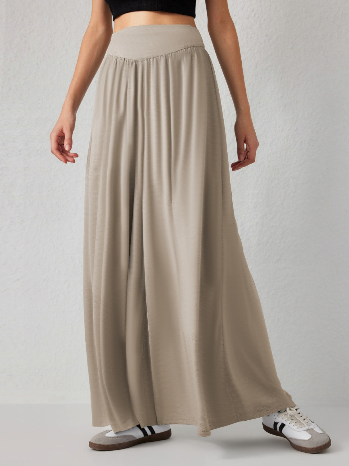 Khaki jersey wide-leg trousers with a drape-front waistband and flowy silhouette.