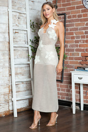 Cream crochet halter midi dress with floral appliques and open knit detail.