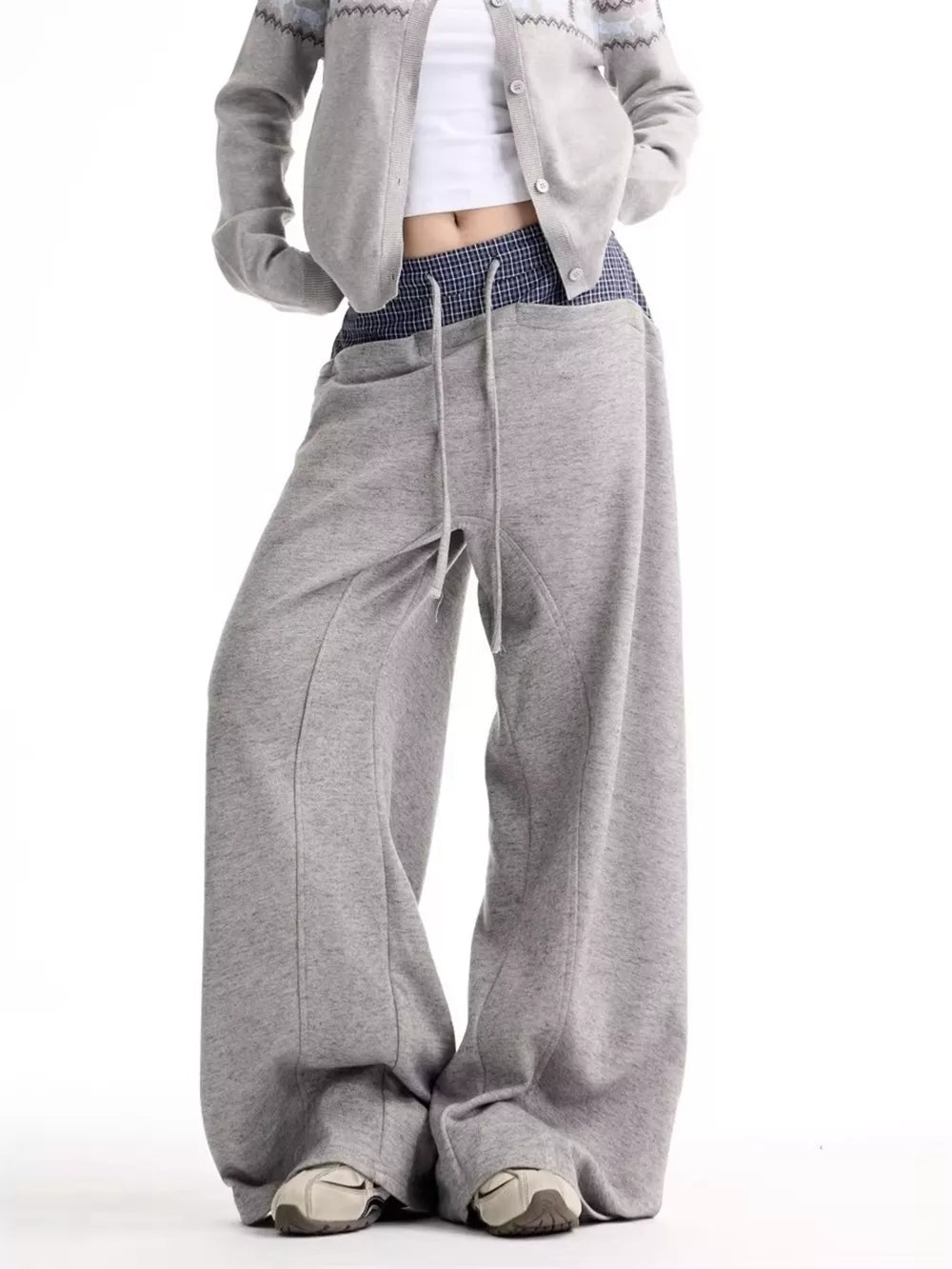 Grey wide-leg sweatpants with drawstring and pockets, styled with a cropped cardigan.