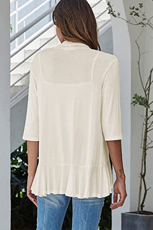 Ivory waterfall cardigan with asymmetric ruffled hem and 3/4 sleeves.