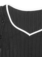 Black ribbed dress with white trim and button detail on sleeve