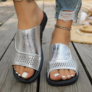 Chic silver hollow-out slide sandals with breathable perforated details.