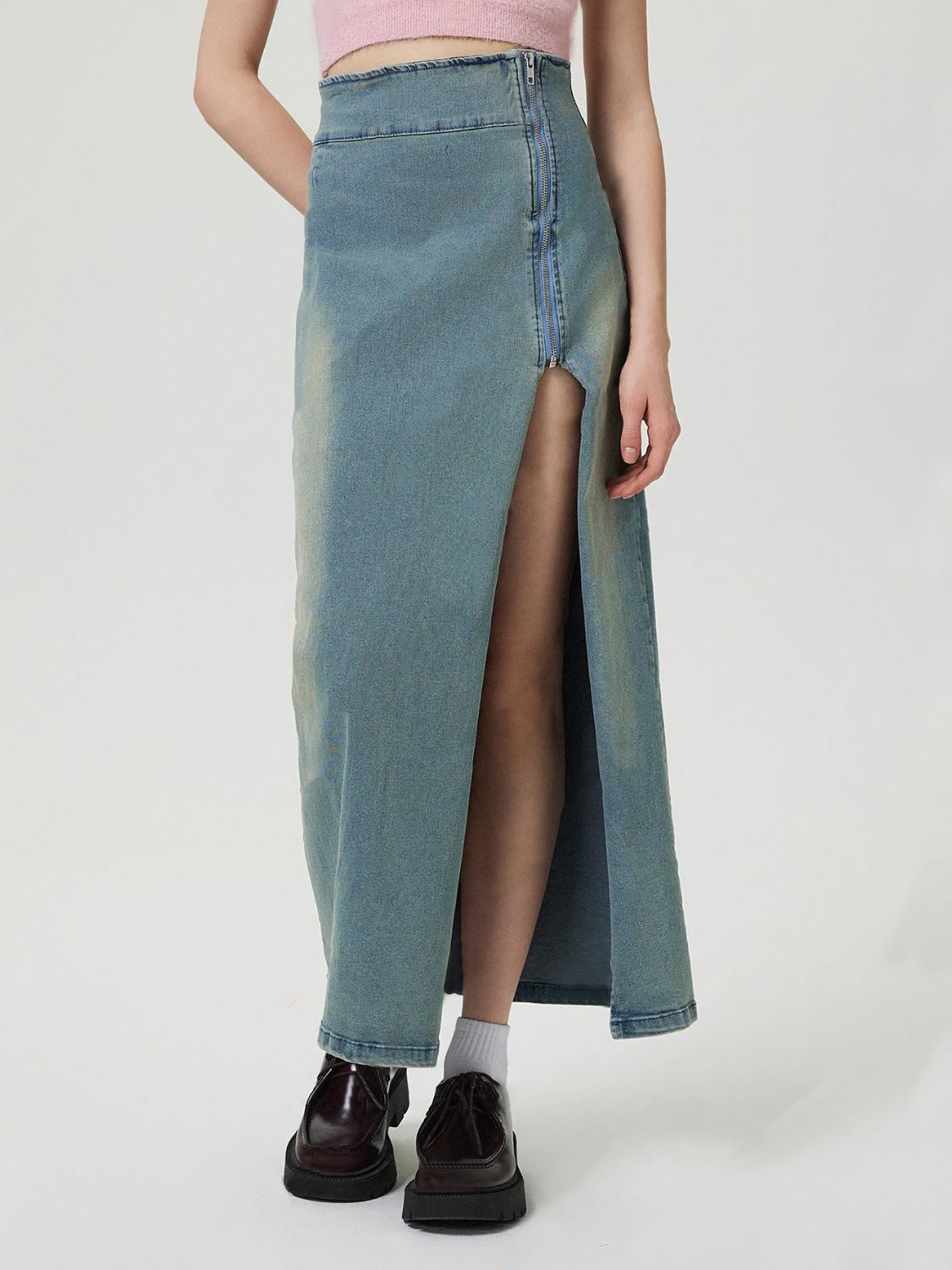 Denim maxi skirt in medium wash with a high waist and front zipper slit.
