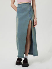 Denim maxi skirt in medium wash with a high waist and front zipper slit.