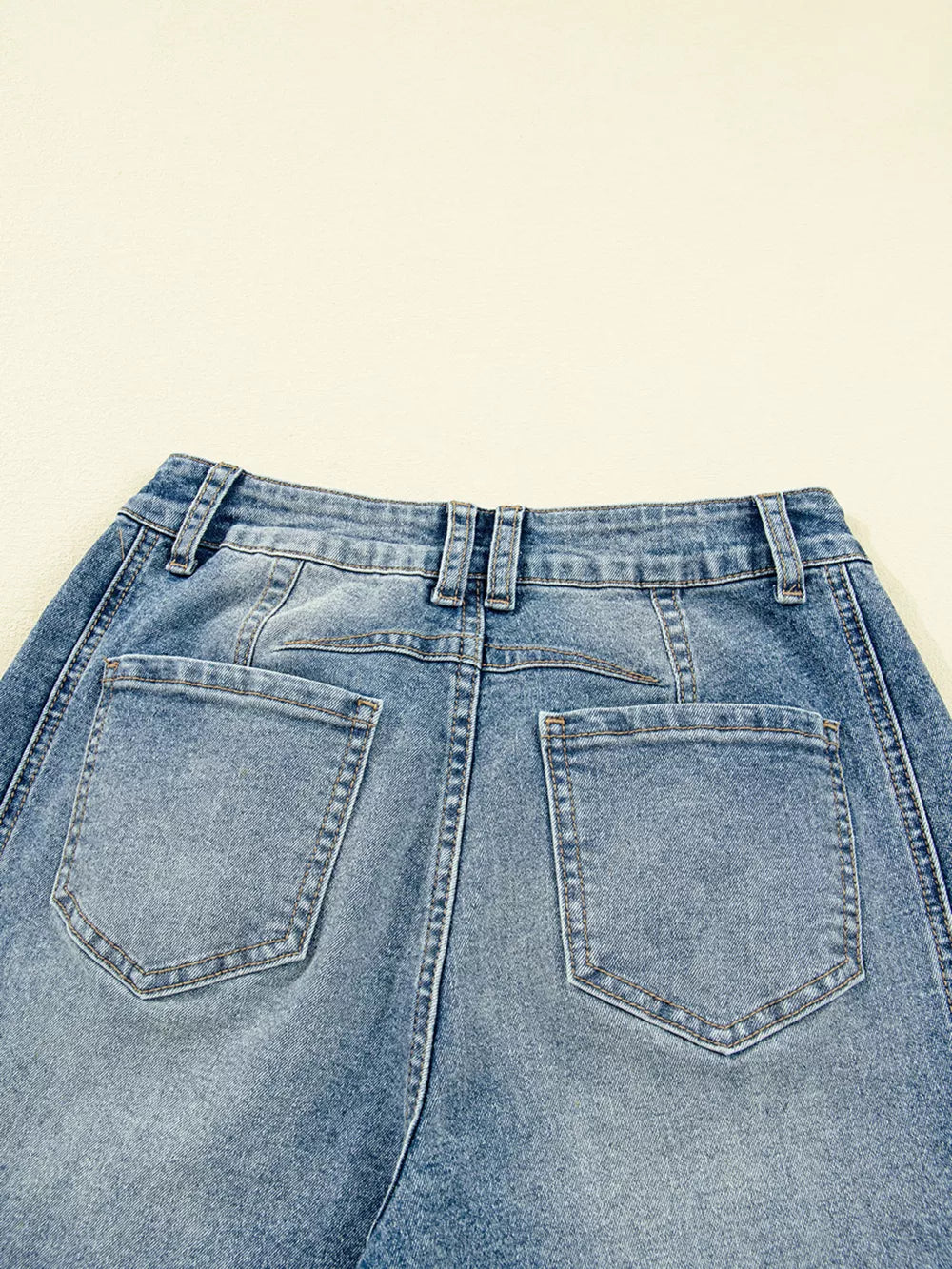 Vintage-inspired high-waisted seam jeans in light wash denim, featuring classic back pockets.