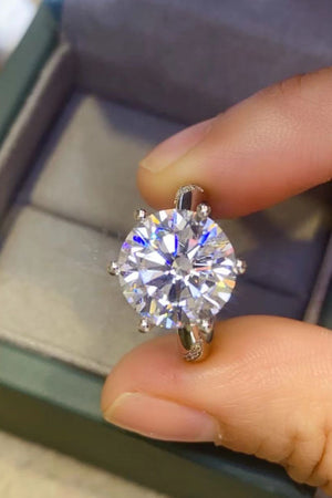 Silver solitaire engagement ring with a large round-cut diamond and pavé band detail.