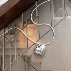 Sleek sterling silver heart pendant necklace with a snake chain.