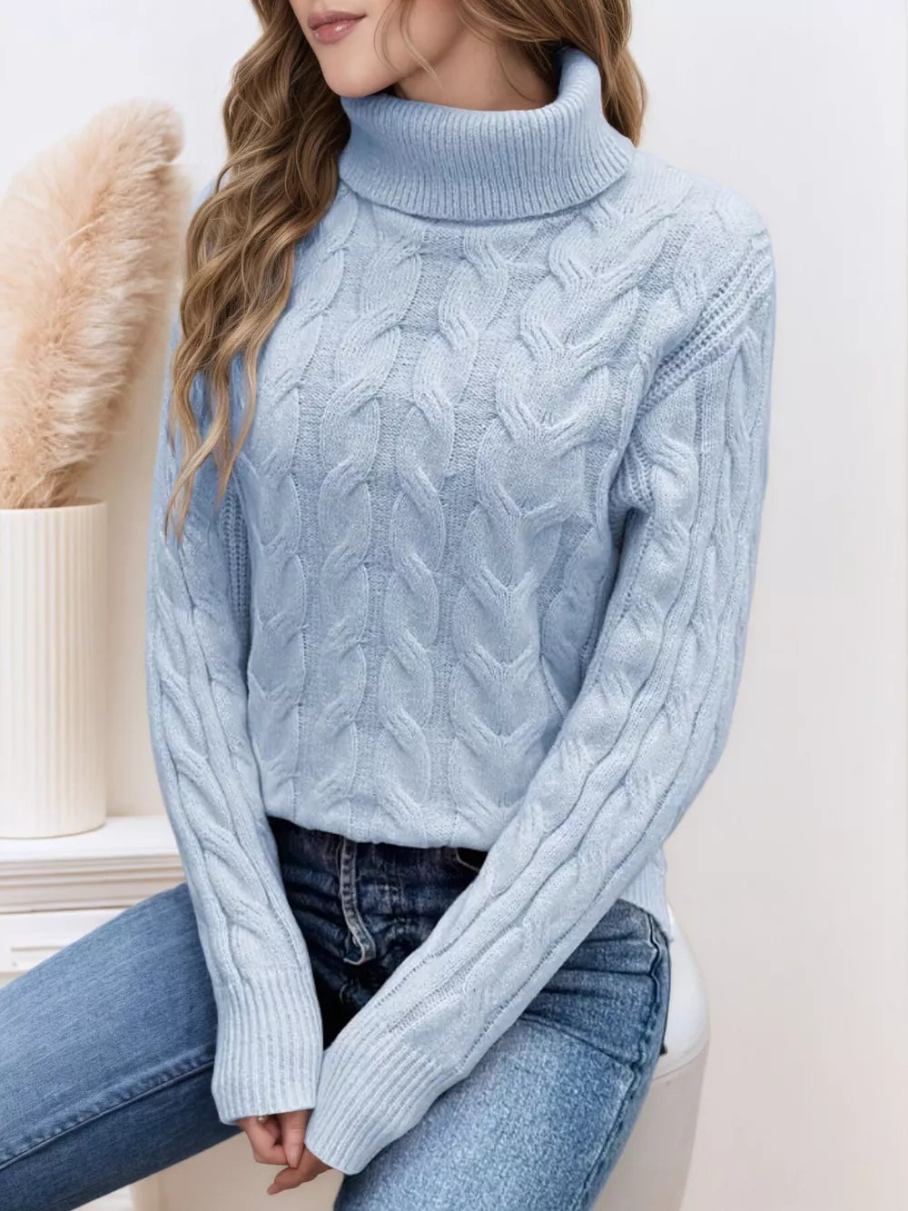 Sky blue cable-knit turtleneck sweater with ribbed cuffs and hem.