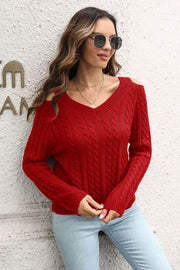 Red cable knit V-neck sweater with cold shoulder detail and long sleeves.