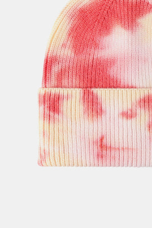 Ribbed knit beanie with pink and yellow dip-dye pattern.