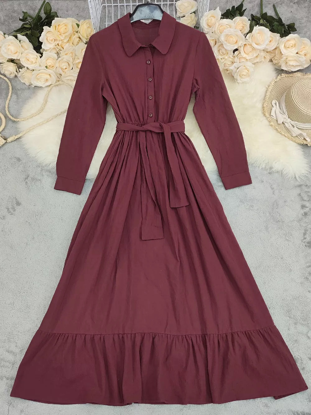 Red belted maxi dress with button front, tie waist, and ruffled hem.