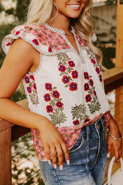 Vibrant floral cotton blouse with ruffled sleeves and striped trim