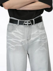 Light wash straight leg denim jeans with whiskering detail and a silver logo belt.