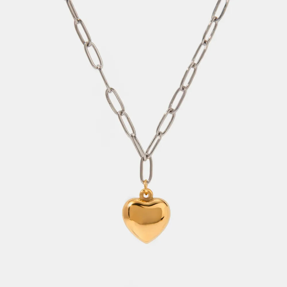 Two-tone chain necklace with a polished gold heart pendant.