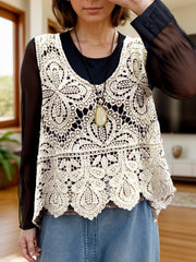 Cream lace overlay cropped vest with intricate floral pattern and scalloped hem.