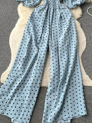 Light Blue polka dot smocked wide-leg romper with puff sleeves.