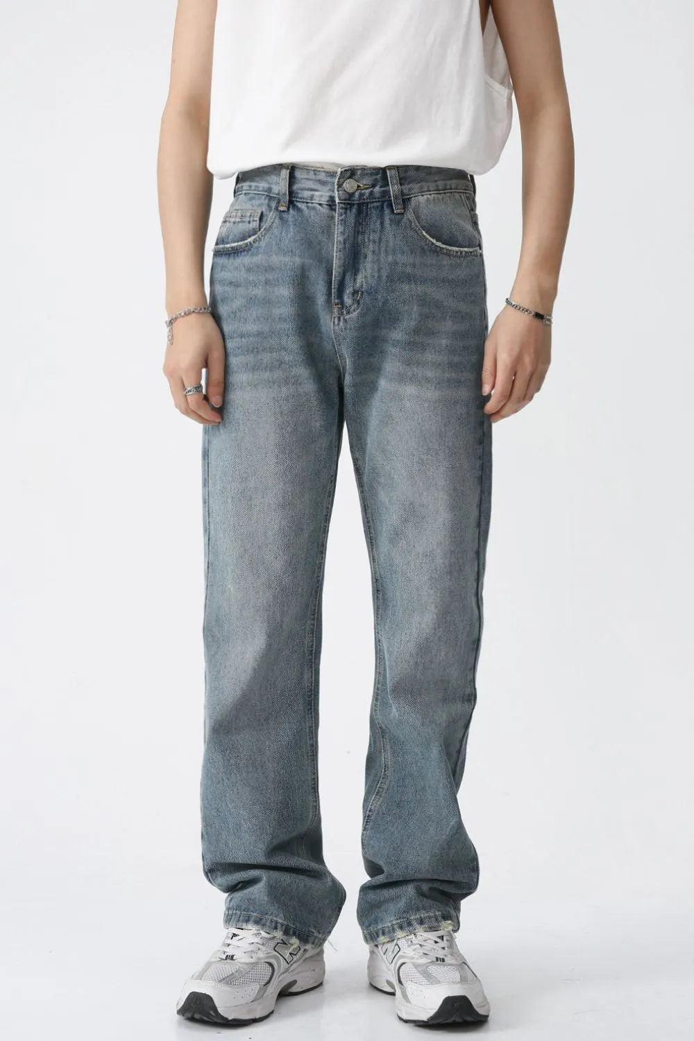 Relaxed wash straight leg denim jeans in medium blue, featuring a classic five-pocket design and a comfortable fit.