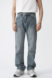 Relaxed wash straight leg denim jeans in medium blue, featuring a classic five-pocket design and a comfortable fit.