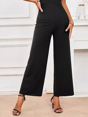Black wide-leg jumpsuit with flutter sleeves and a high waist.