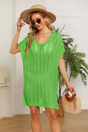 Green knit swim dress with V-neck and short slit sleeves, featuring a textured pattern.