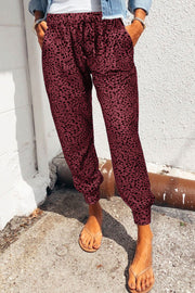Wine leopard print drawstring trousers with pockets and elastic cuffs.