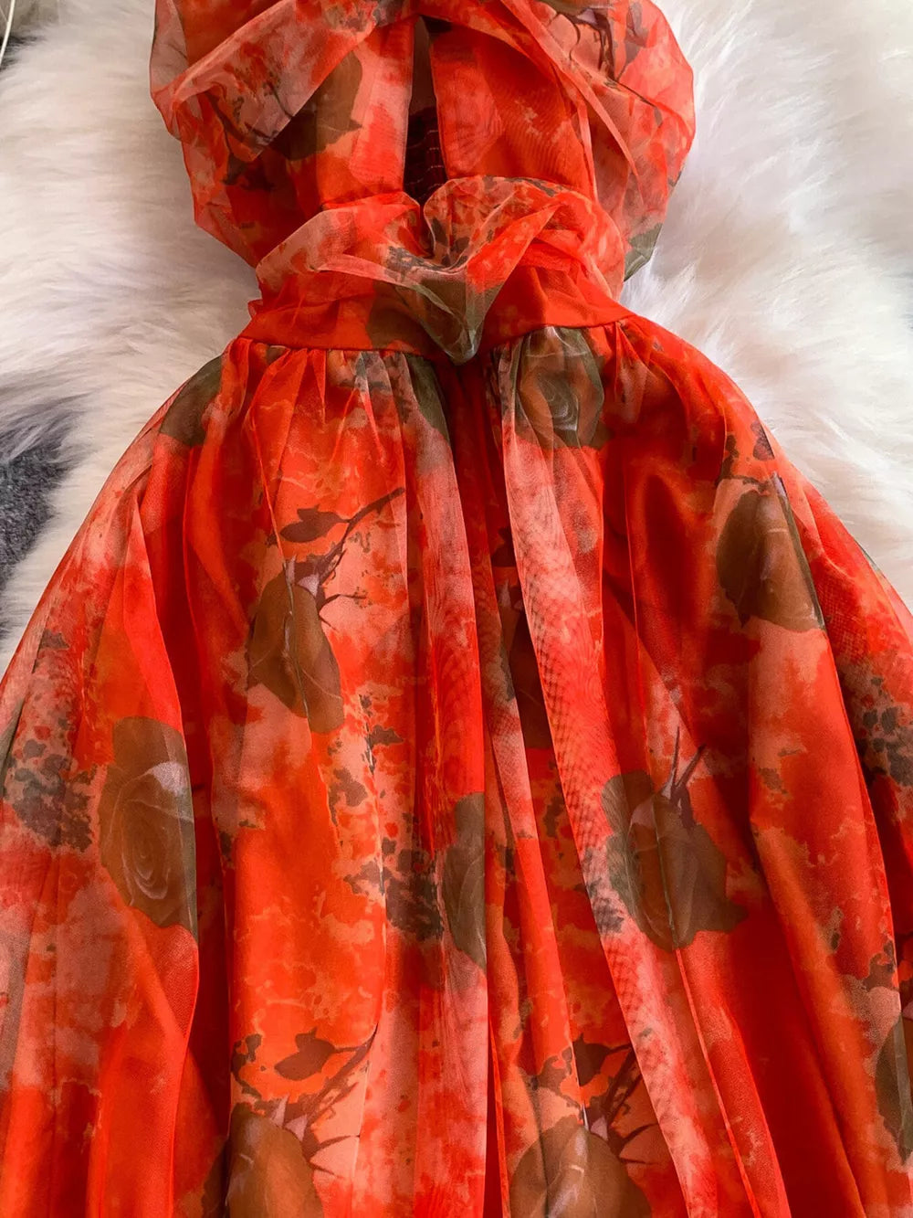 Orange floral mesh maxi dress with layered detail and a ruffled neckline.