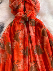 Orange floral mesh maxi dress with layered detail and a ruffled neckline.