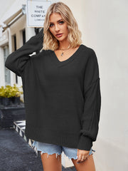 Oversized black knit V-neck sweater with slouchy fit and ribbed cuffs.