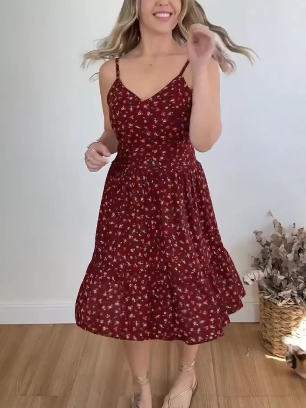 Charming floral ruffle hem midi dress with spaghetti straps and a tiered skirt.