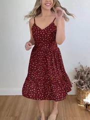 Charming floral ruffle hem midi dress with spaghetti straps and a tiered skirt.