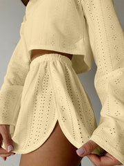 Perforated crop top and shorts set in light yellow with a textured knit and cutout detail.