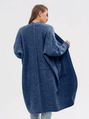 Oversized acrylic knit cocoon cardigan in Dusty Blue with pockets and ribbed cuffs.