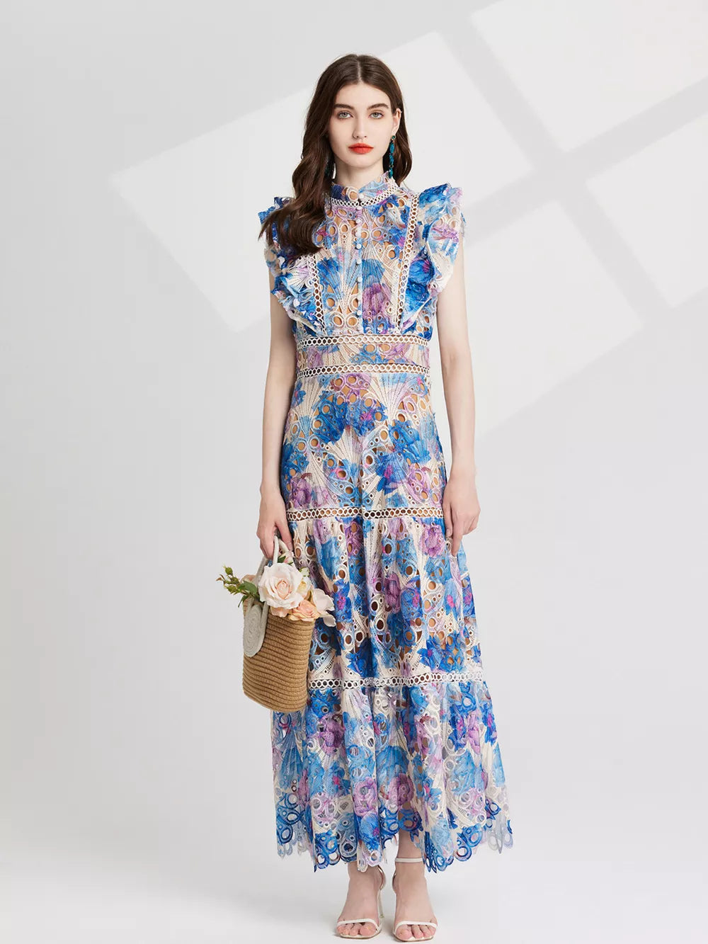 Maxi dress with floral lace, cutout details, and ruffled sleeves in blue and pink purple.