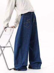 Men's dark blue wide leg jeans with contrast stitching and embroidered back pockets.