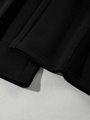 Black cotton joggers with visible stitching detail on the hem.