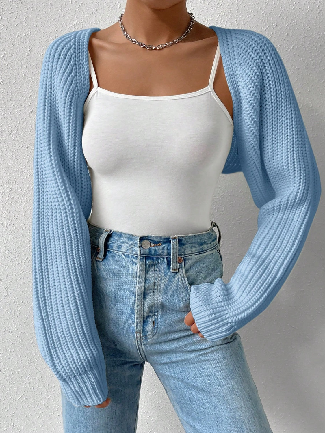 Light blue acrylic knit bolero shrug with long sleeves and ribbed texture.