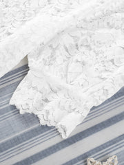 White lace short sleeve blouse with floral pattern and scalloped hem detail.