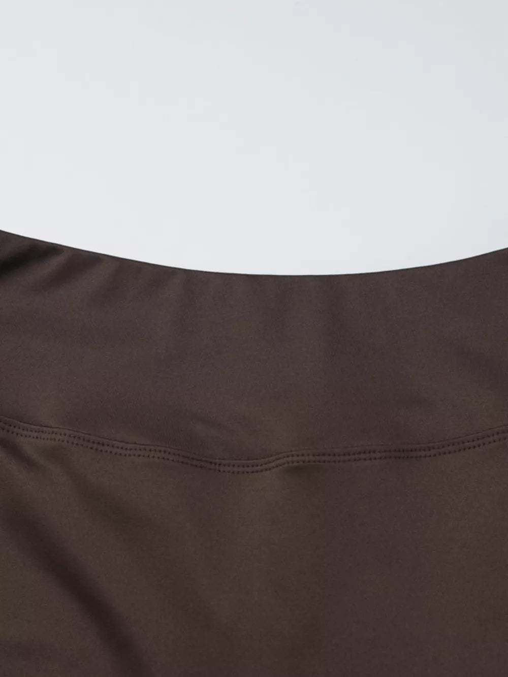 Brown halter crop top and wide-leg pants set detail showing stitching.
